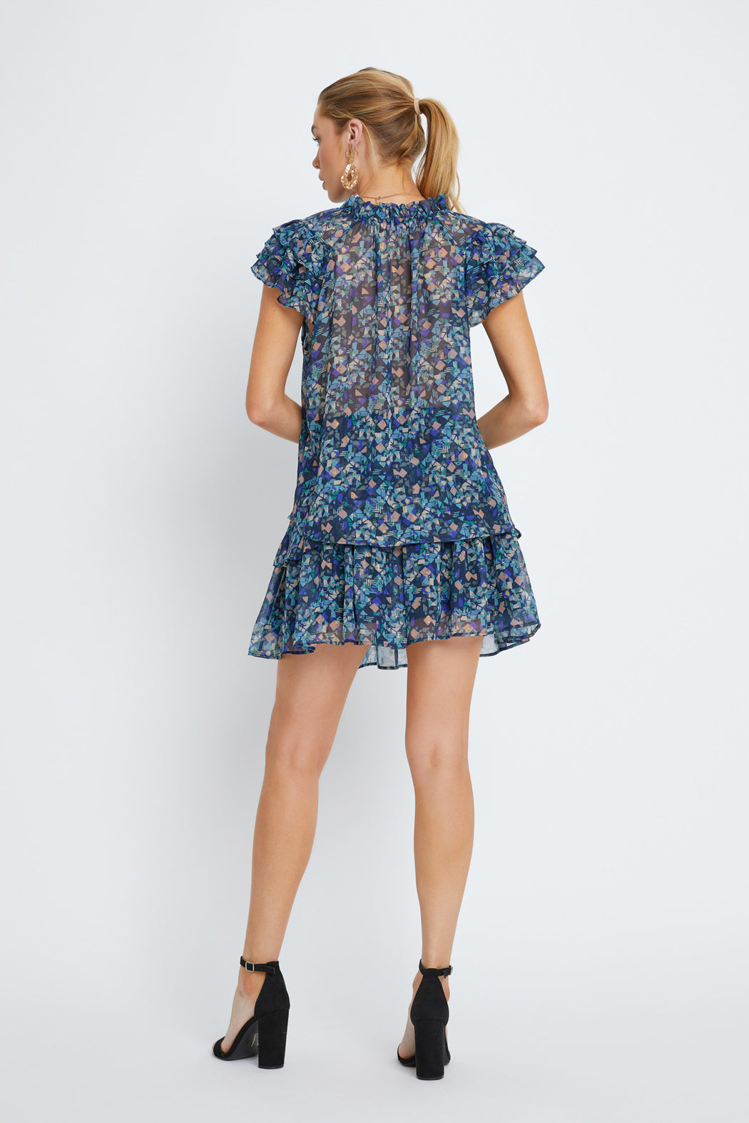 Woman wearing a blue floral dress on a white background