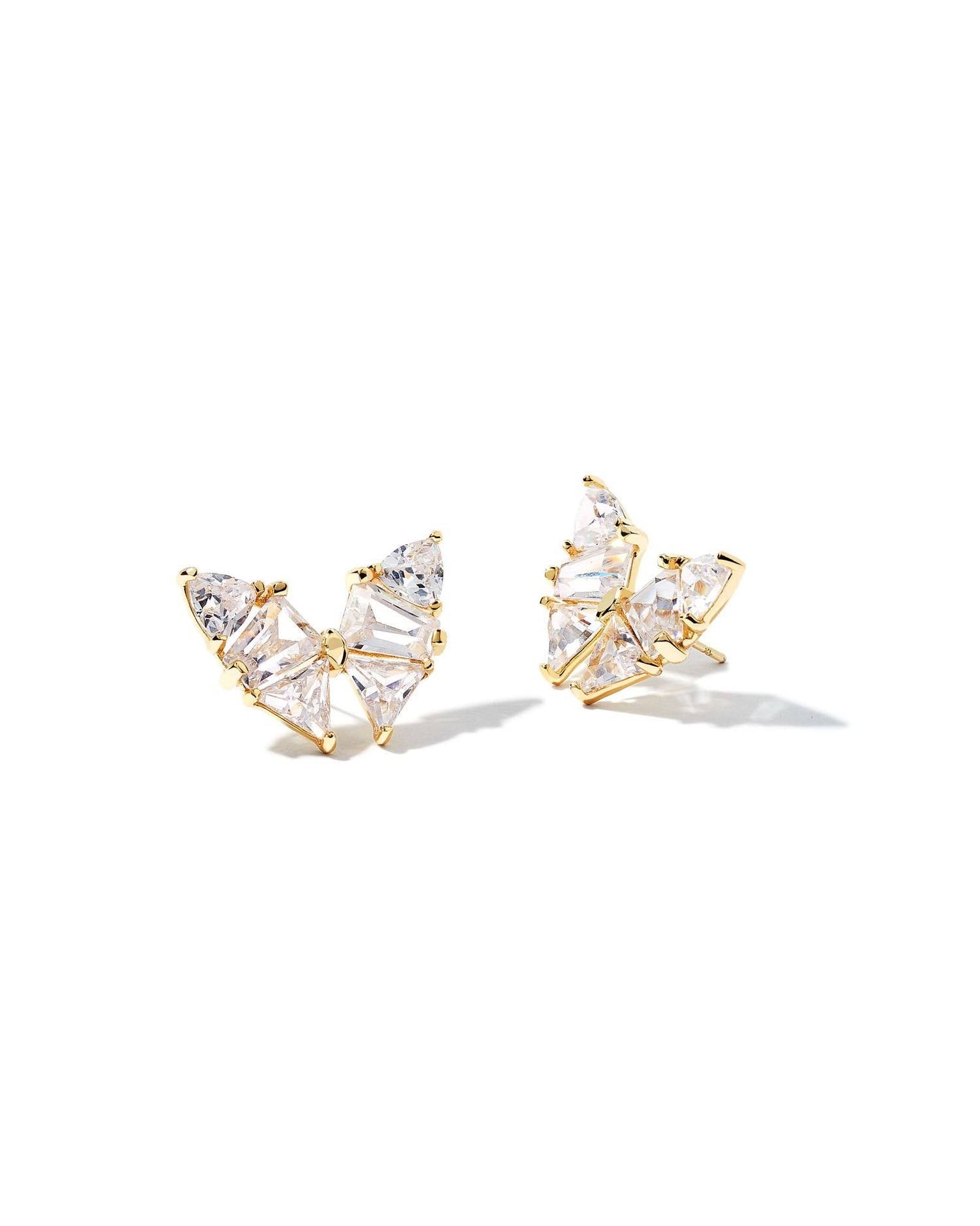 Gold butterfly-shaped earrings with clear gemstones on a white background