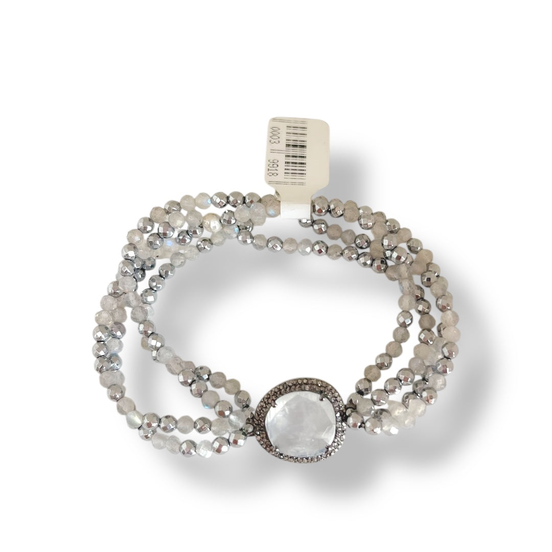 Multistrand beaded bracelet with a central stone on a white background