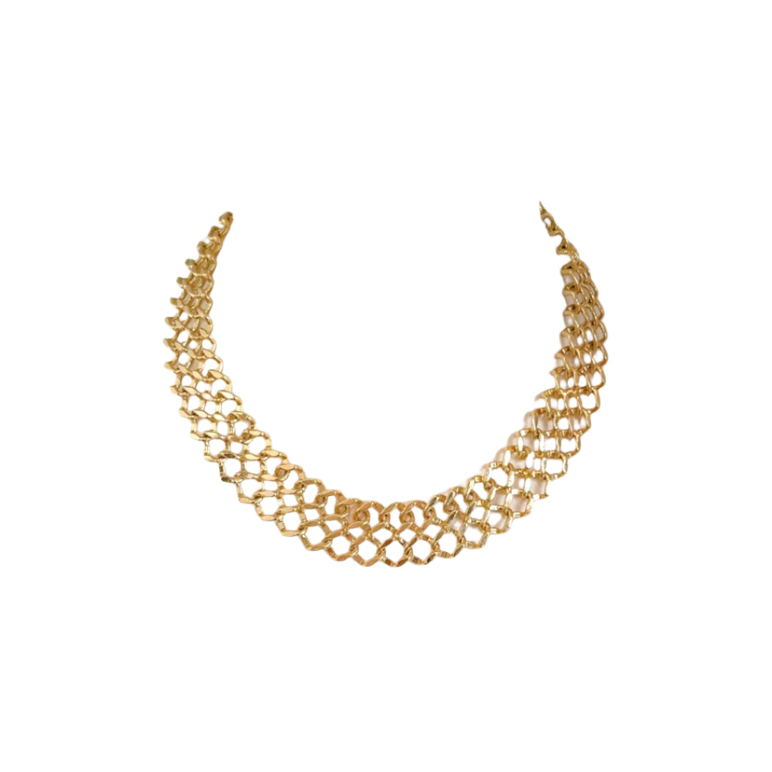 Gold necklace on a white mannequin bust with a plain background