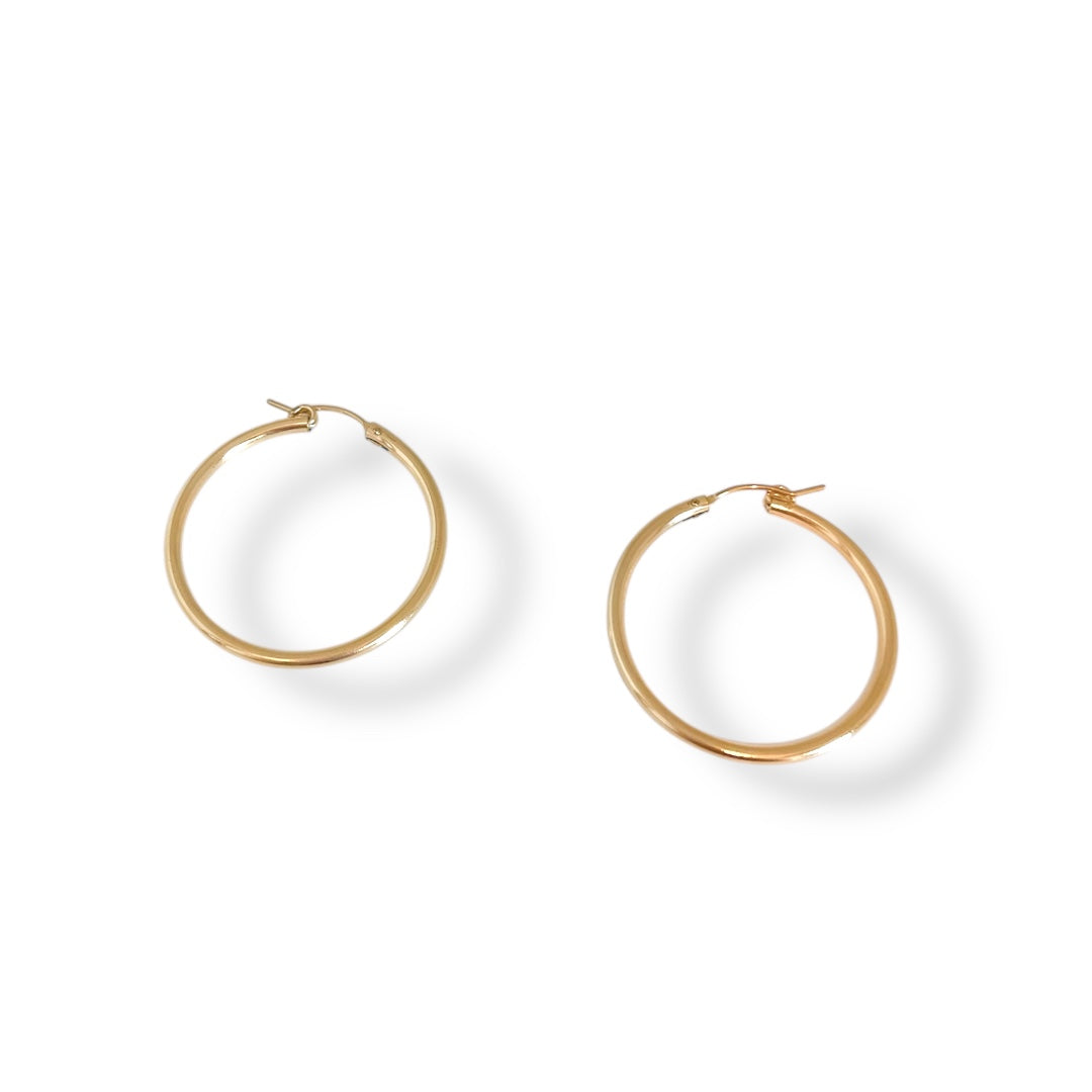 Gold hoop earrings on a white background