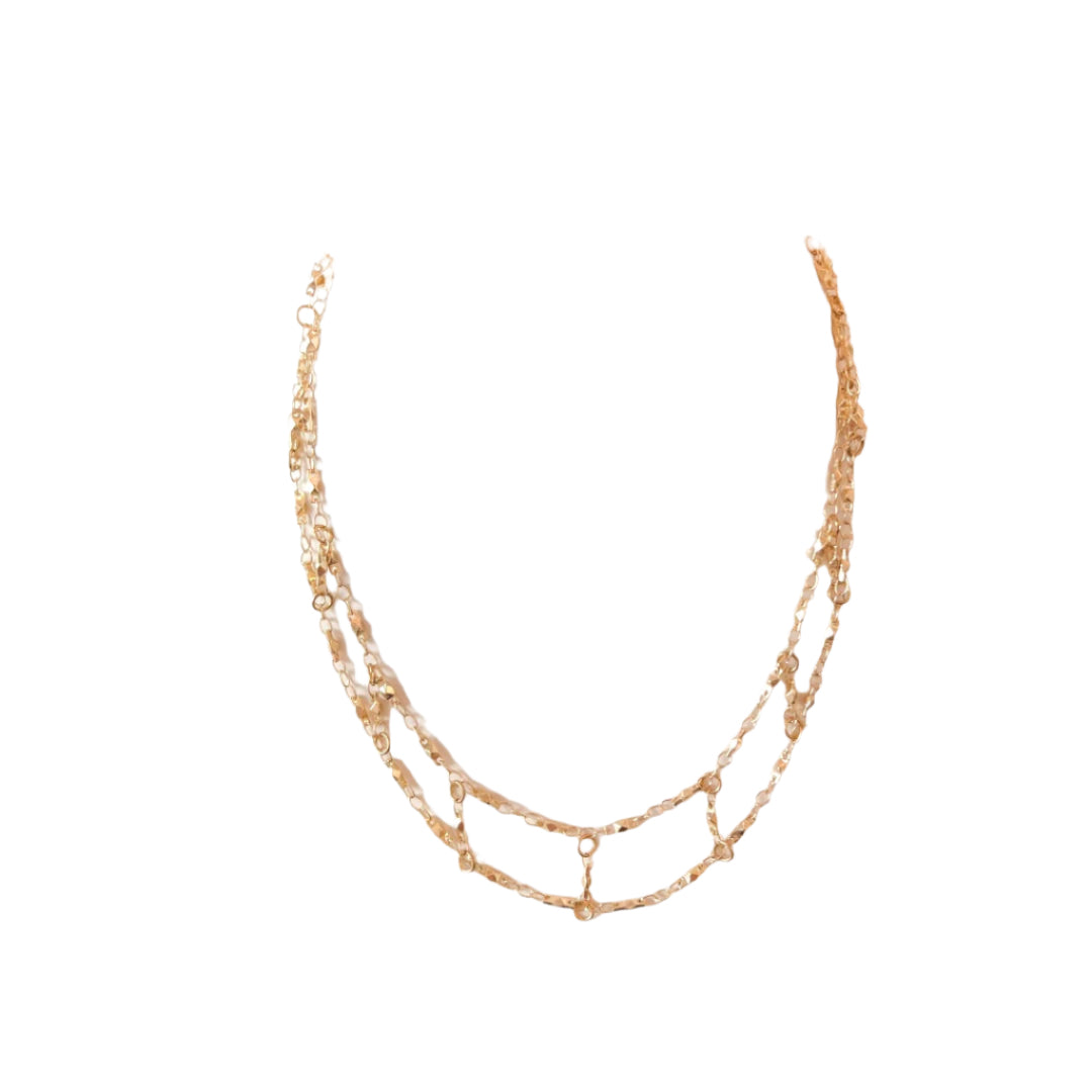 Gold necklace on a mannequin bust against a white background