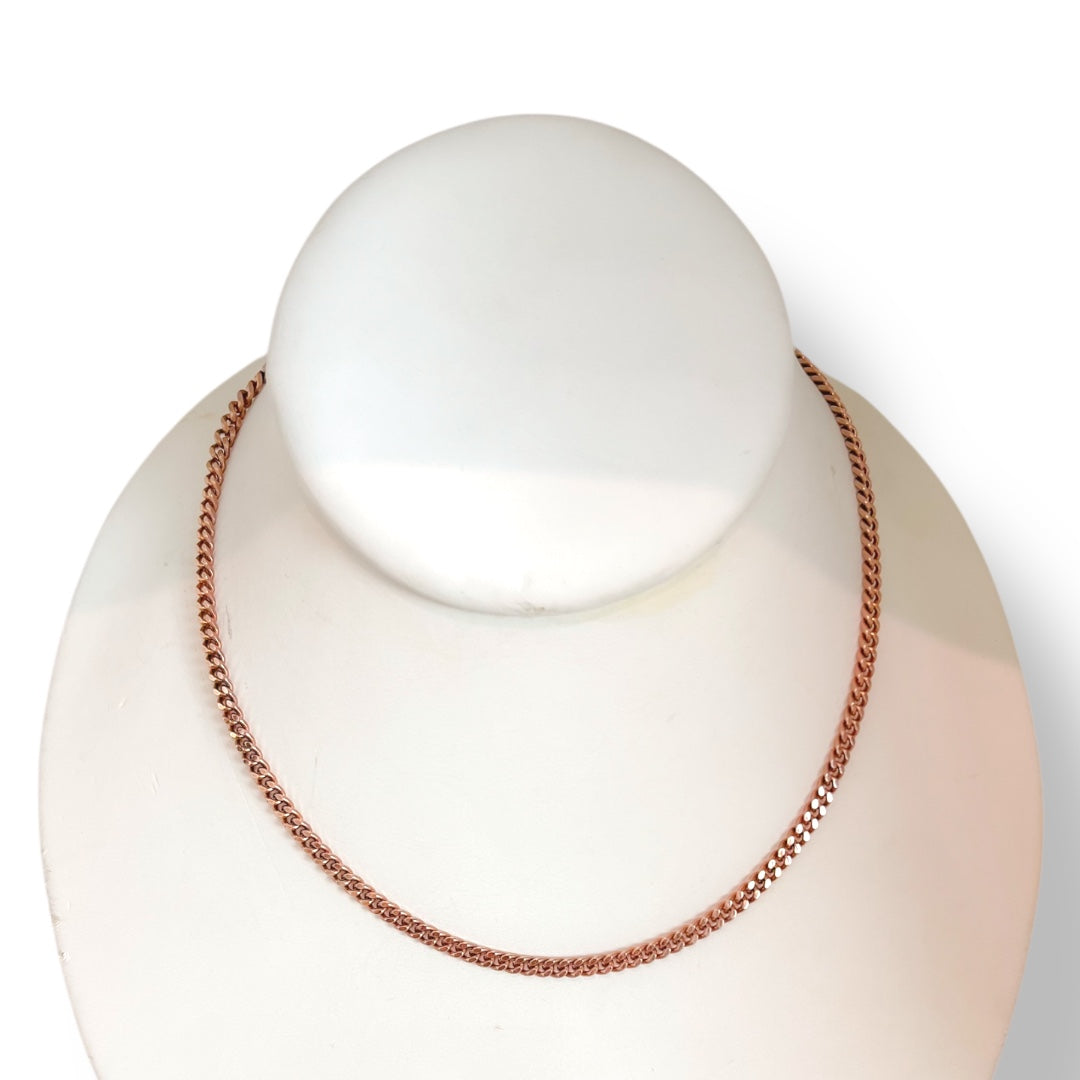 Rose gold necklace on a mannequin bust against a white background