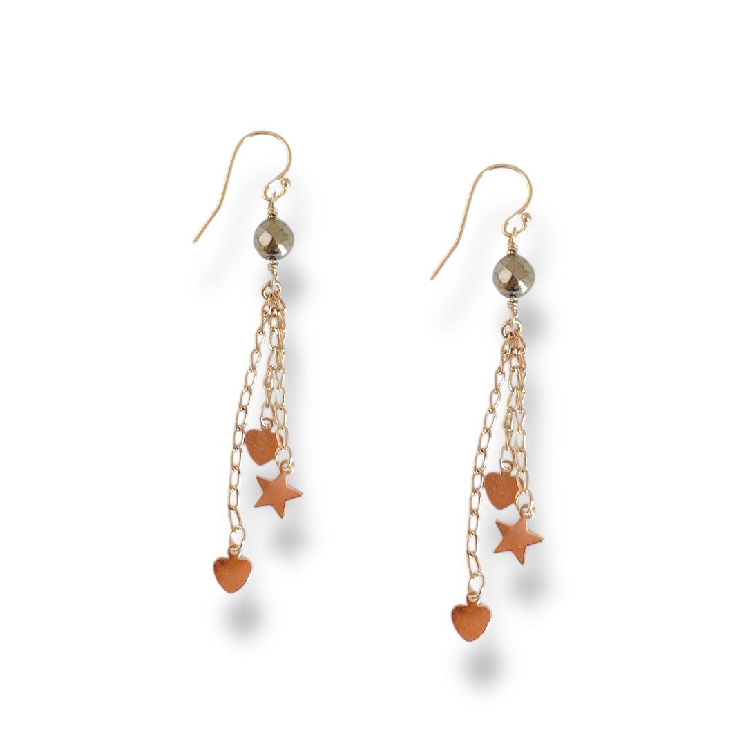 Pair of earrings with star and heart charms on a white background