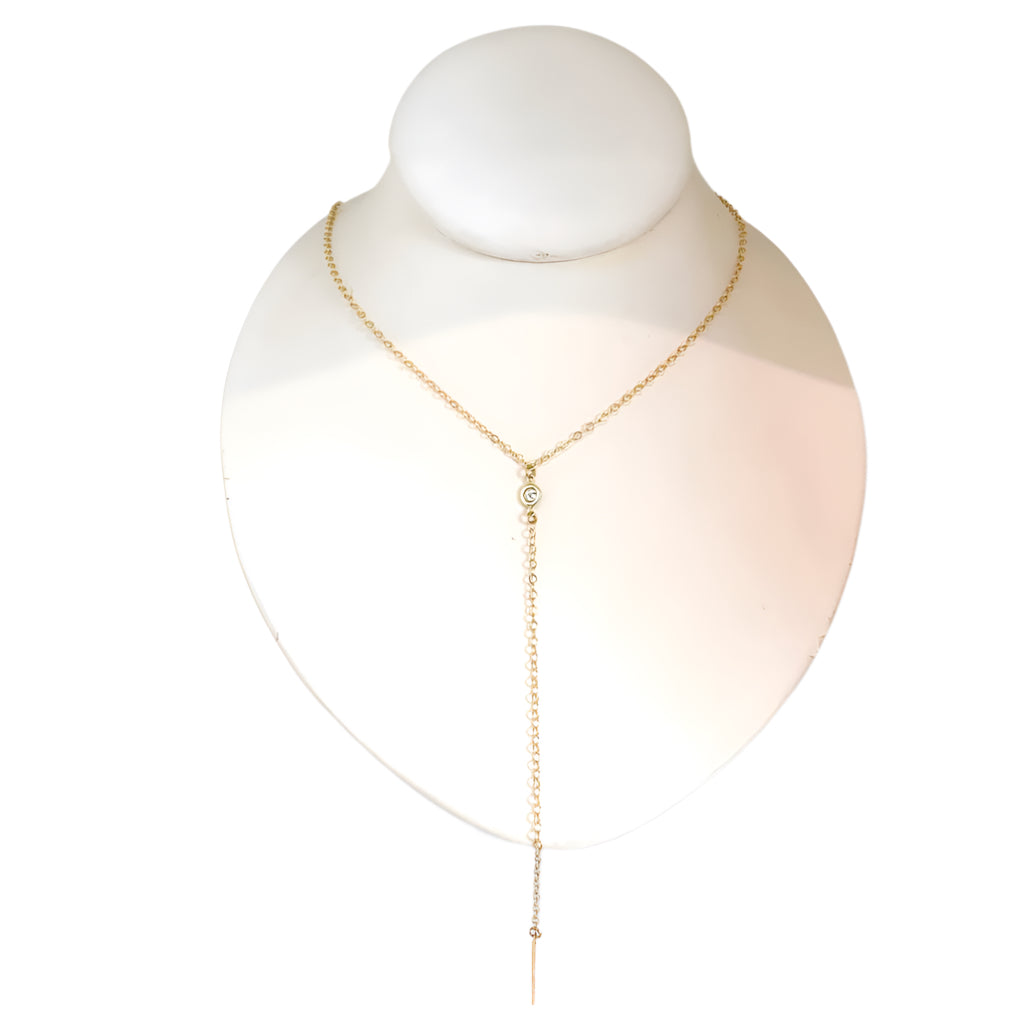 Gold necklace on a mannequin bust against a white background