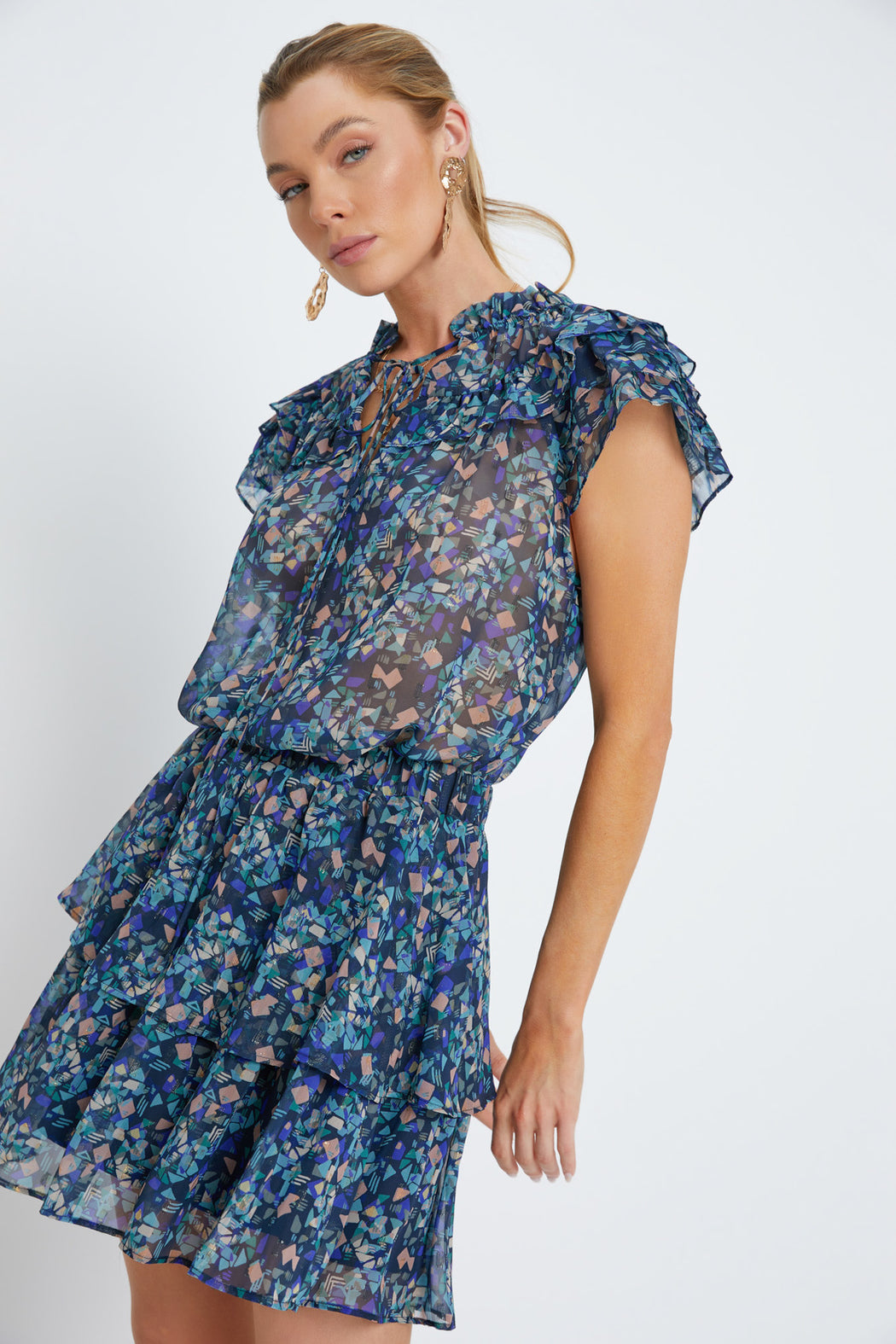 Woman wearing a blue floral dress on a white background
