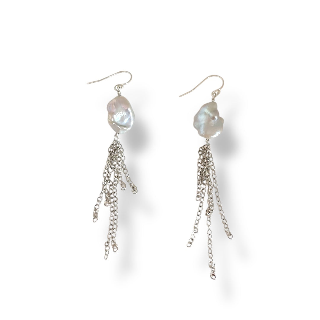 Pair of pearl and chain earrings on a white background