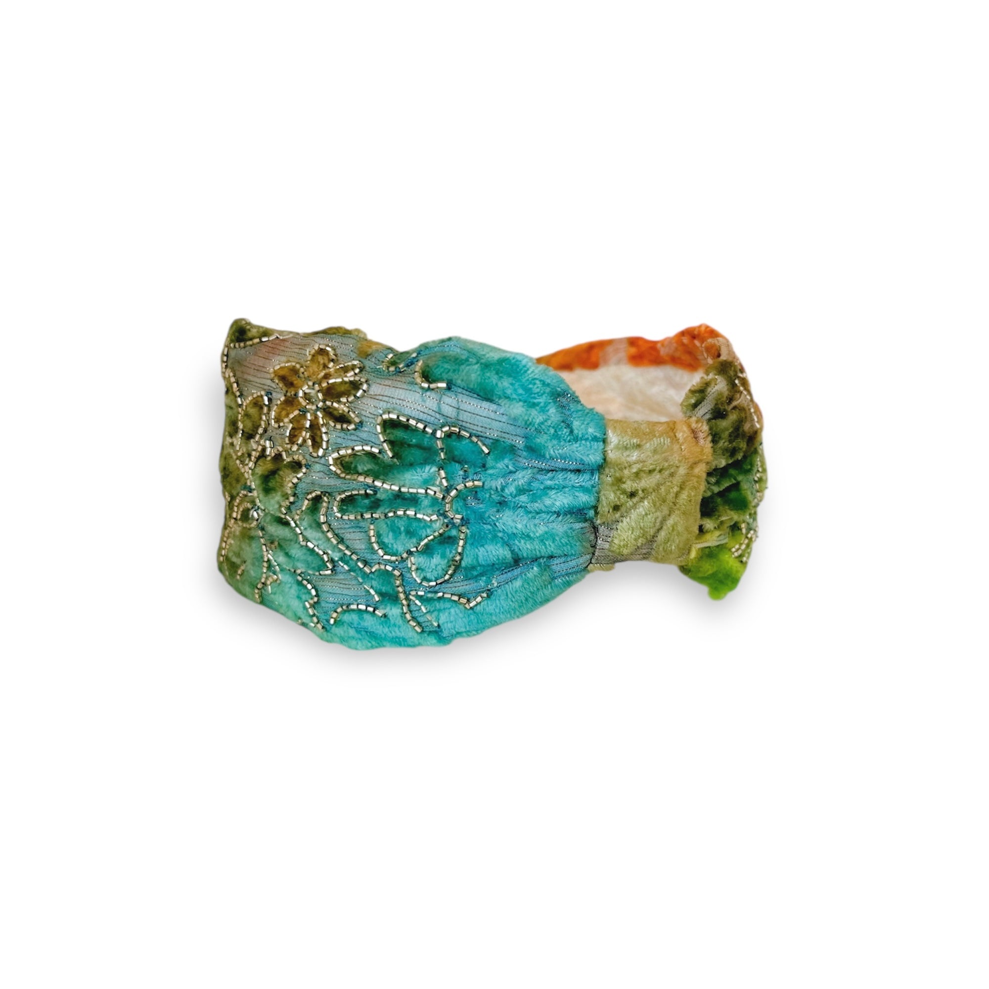 Decorative bracelet with turquoise and gold design on a white background