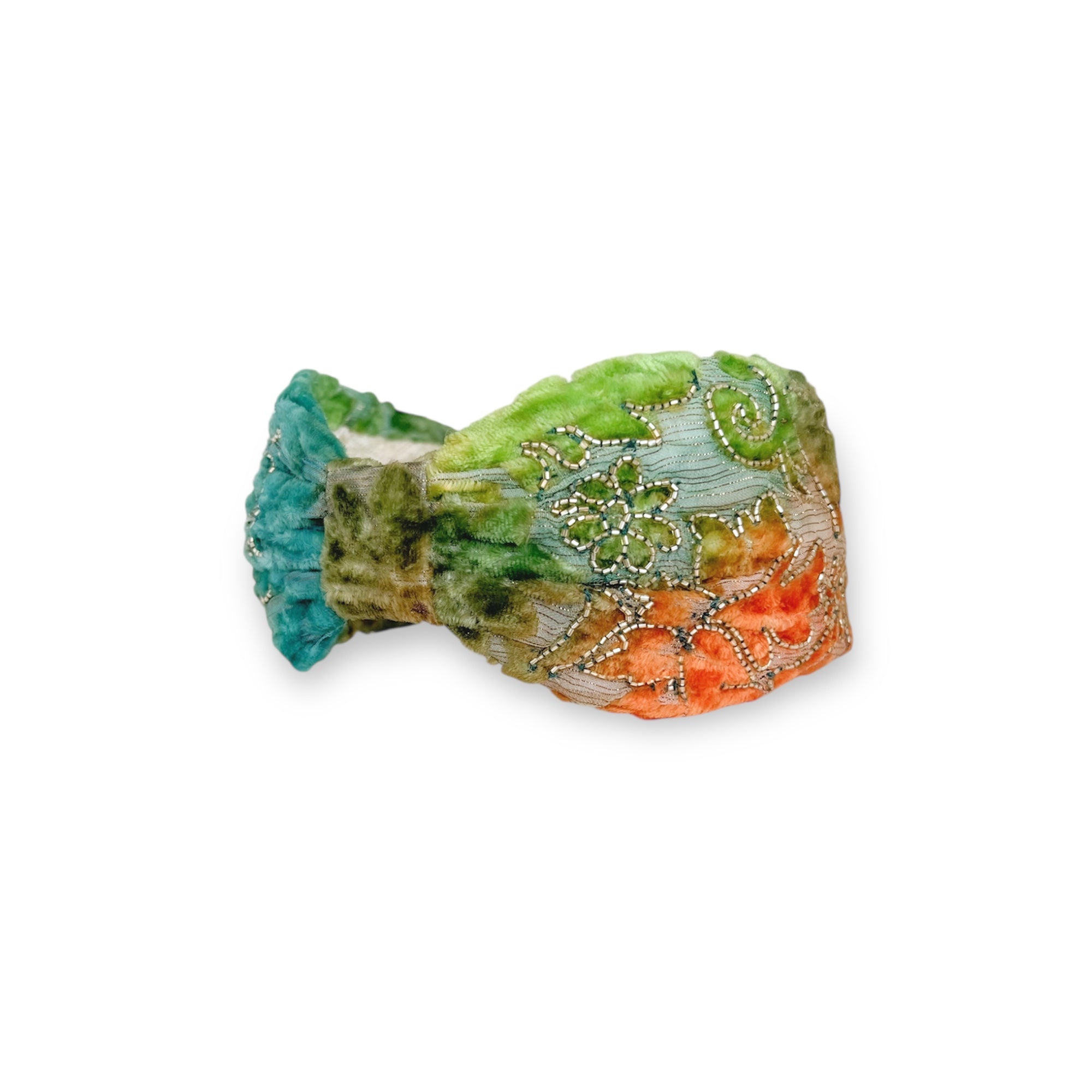 Decorative stone with green, orange, and blue colors on a white background