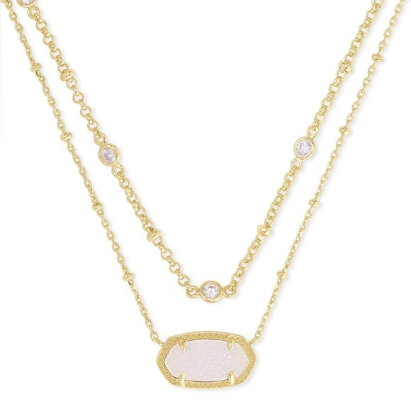 Gold necklace with a white stone pendant on a white background