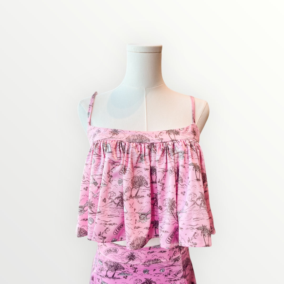 Pink floral dress on a mannequin against a white background