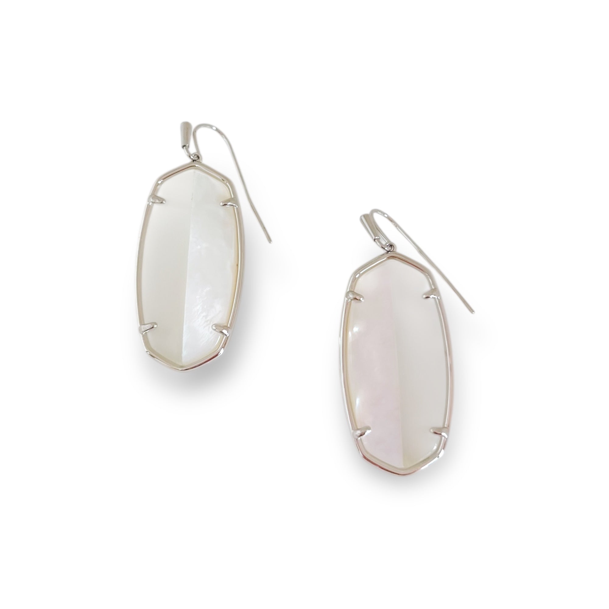 Pair of silver earrings with clear stone on a white background