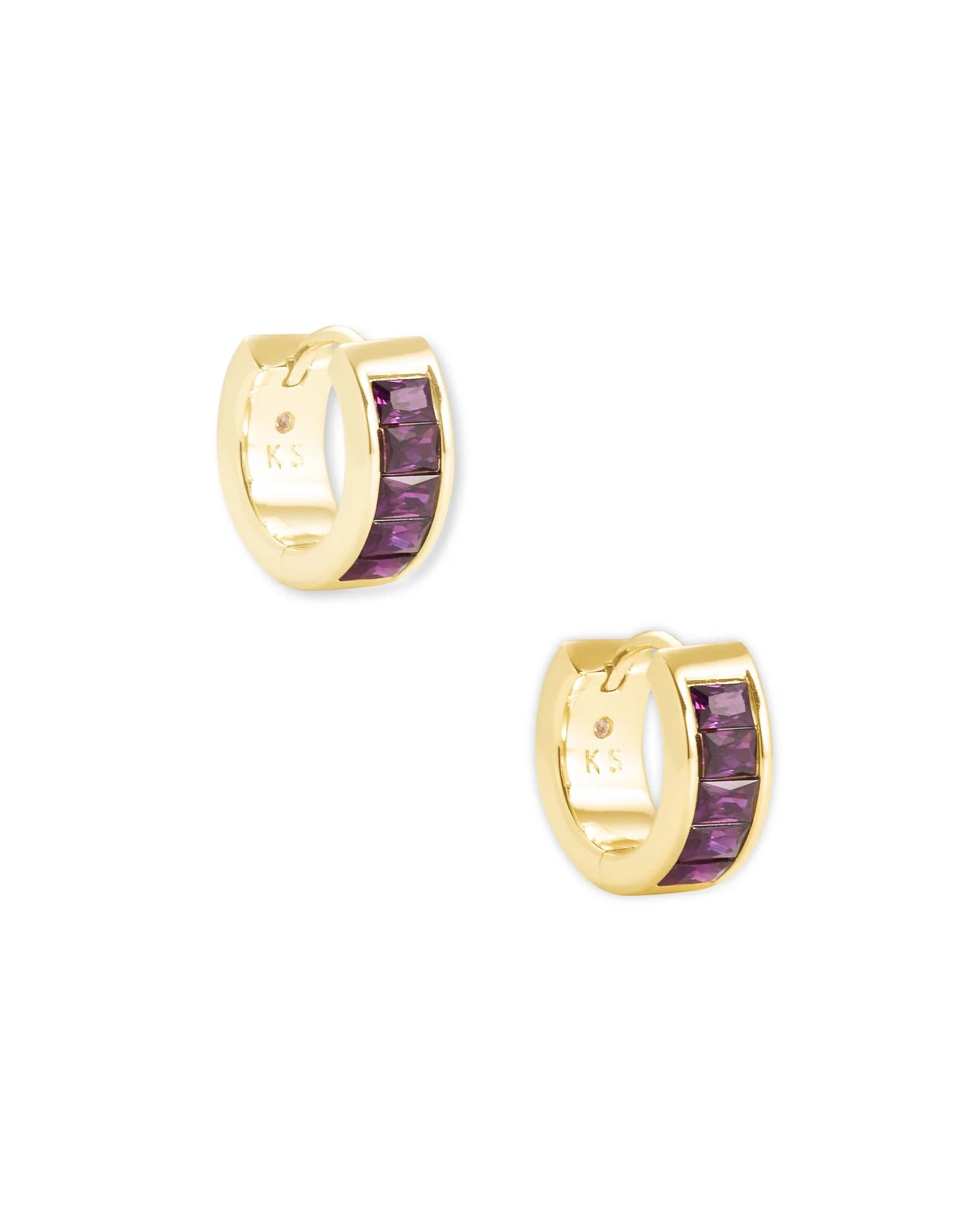 Gold hoop earrings with purple gemstones on a white background