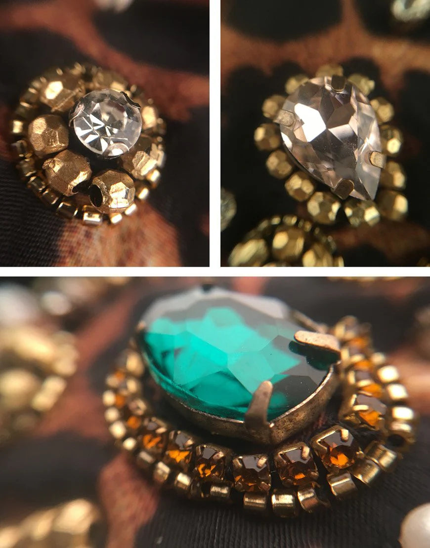 Close-up of decorative buttons with gemstone-like designs on a textured surface.