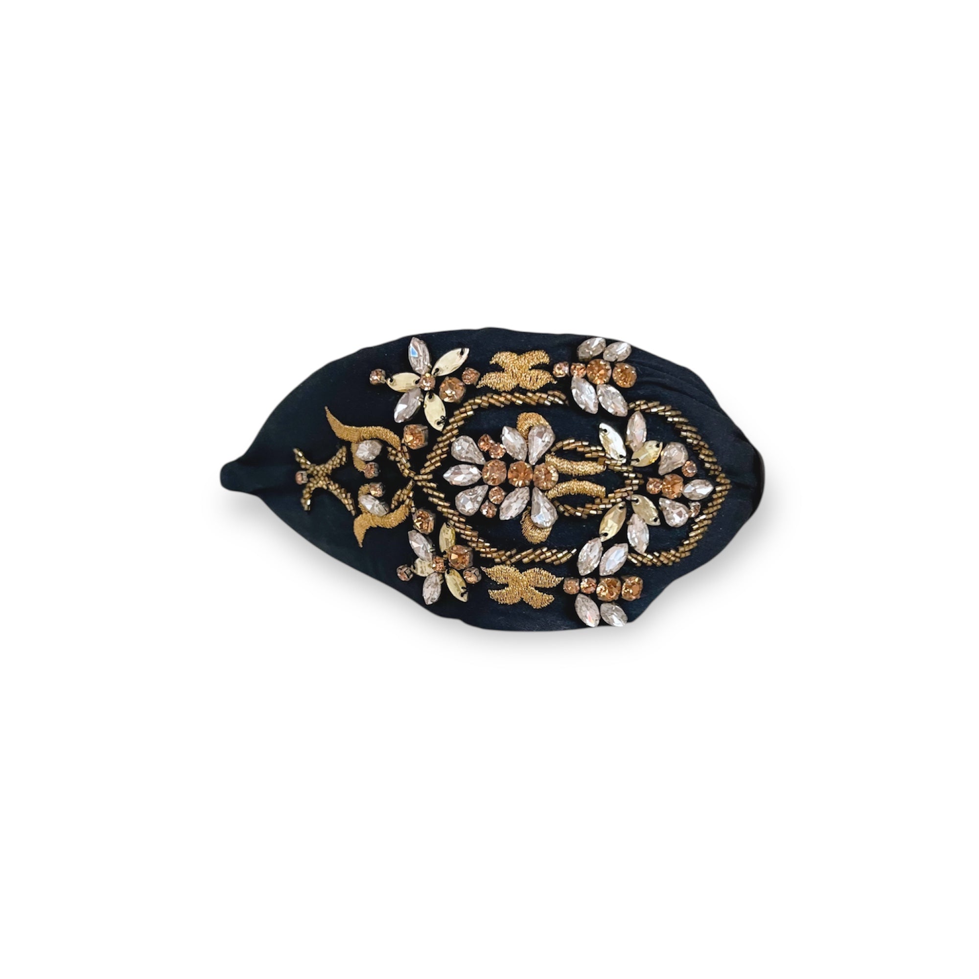 Decorative headband with gold and white embellishments on a black background