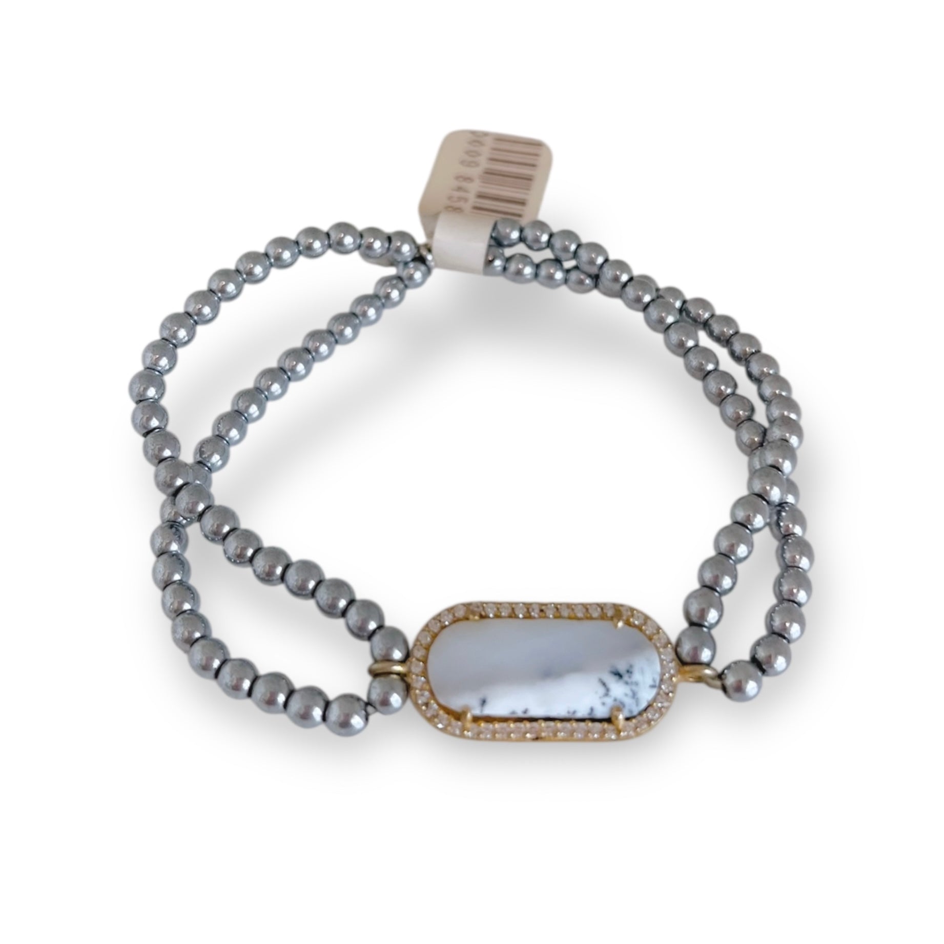 Gray beaded bracelet with a gold and white clasp on a white background